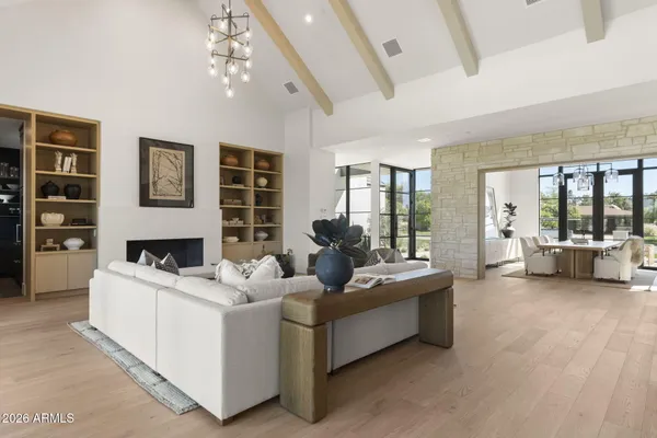 a bedroom with furniture and large windows