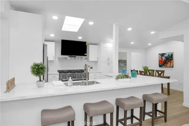a kitchen with granite countertop a table and chairs in it