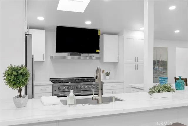 a kitchen with a microwave a stove and cabinets