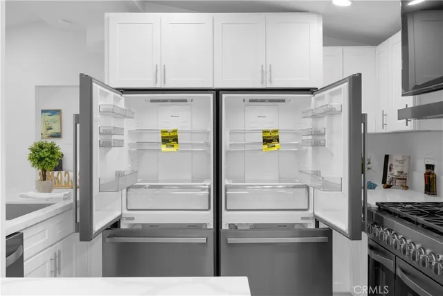 a kitchen with a refrigerator and a stove