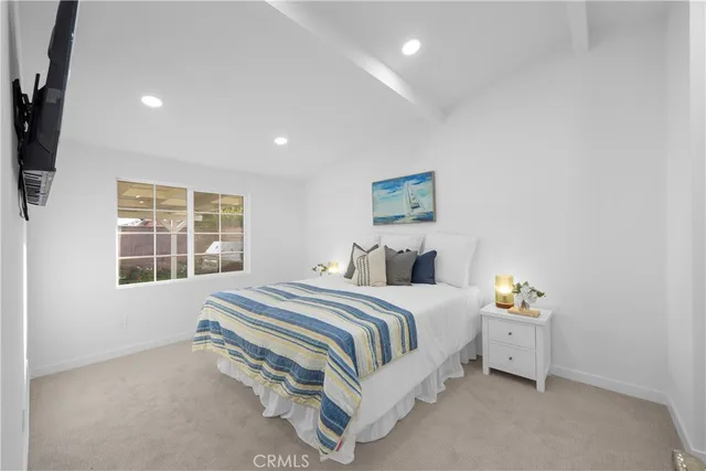 a spacious bedroom with a bed a couch and a window