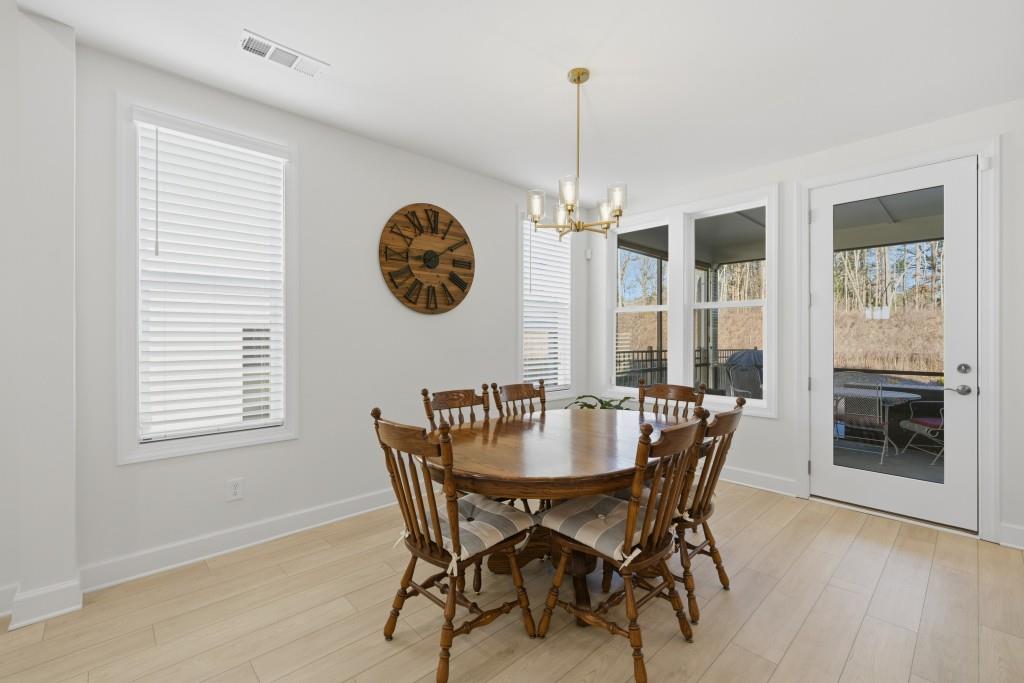 226 Geneva Way Hoschton, GA 30548 - Photo 13 of 84 a view of a dining room with furniture window and wooden floor