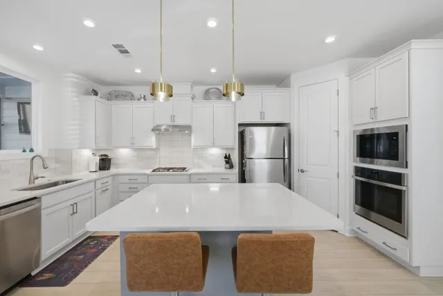 a spacious bedroom with a bed and a chandelier