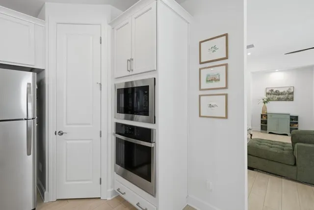 a view of a room with wooden floor and white walls