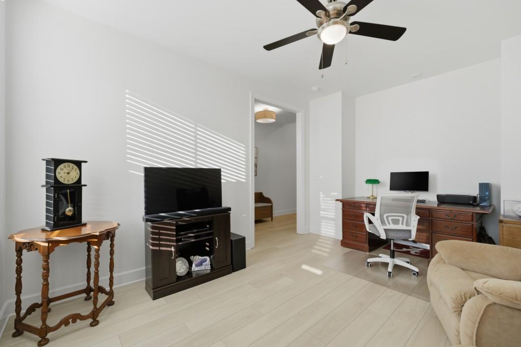 226 Geneva Way Hoschton, GA 30548 - Photo 24 of 84 a view of a livingroom with furniture and a flat screen tv