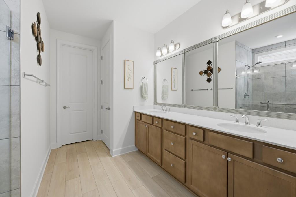 226 Geneva Way Hoschton, GA 30548 - Photo 29 of 84 a spacious bathroom with a double vanity sink mirror and double