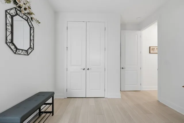 a living room with furniture a large window and wood floor