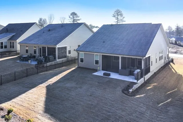 a view of a house with yard and sitting area