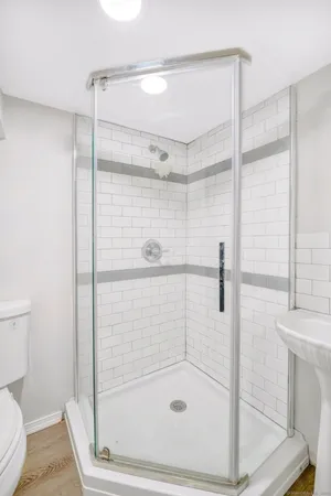 a bathroom with a shower and toilet