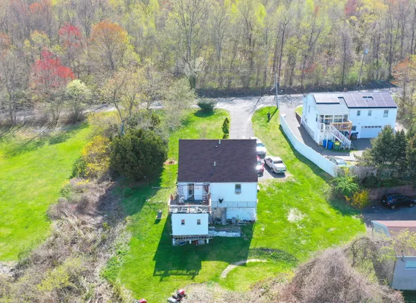 a aerial view of a house with a garden and a yard