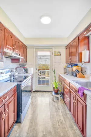 a kitchen with stainless steel appliances a sink and a large window