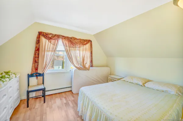 a bedroom with a bed and a window