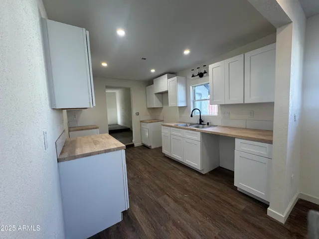 a kitchen with a sink a stove a refrigerator and a microwave