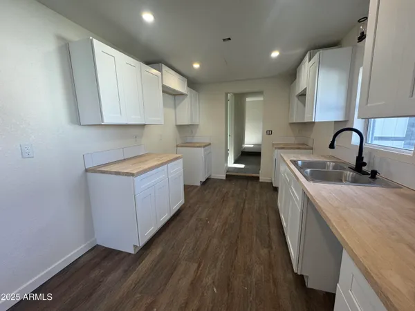 a kitchen with a sink a counter top space and cabinets