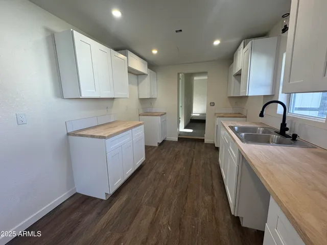 a kitchen with a sink a counter top space and cabinets