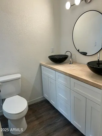 a bathroom with a toilet and a mirror