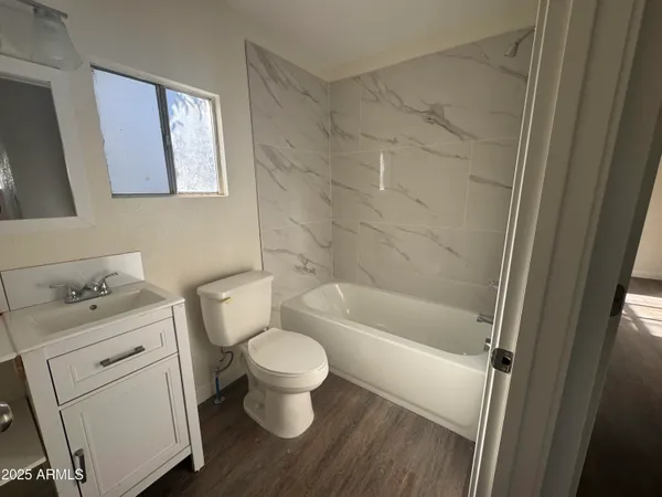 a bathroom with a toilet a sink and bathtub