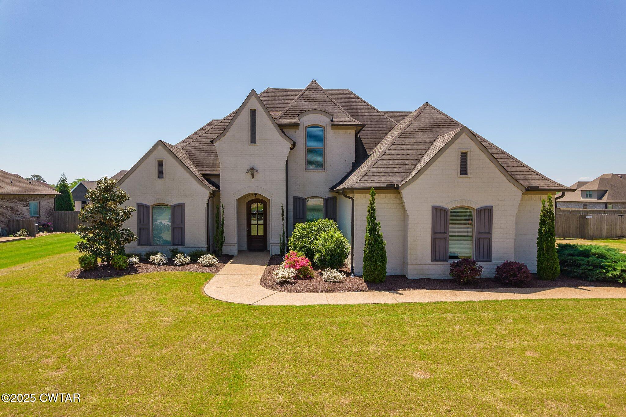 a front view of house with yard outdoor seating and barbeque oven