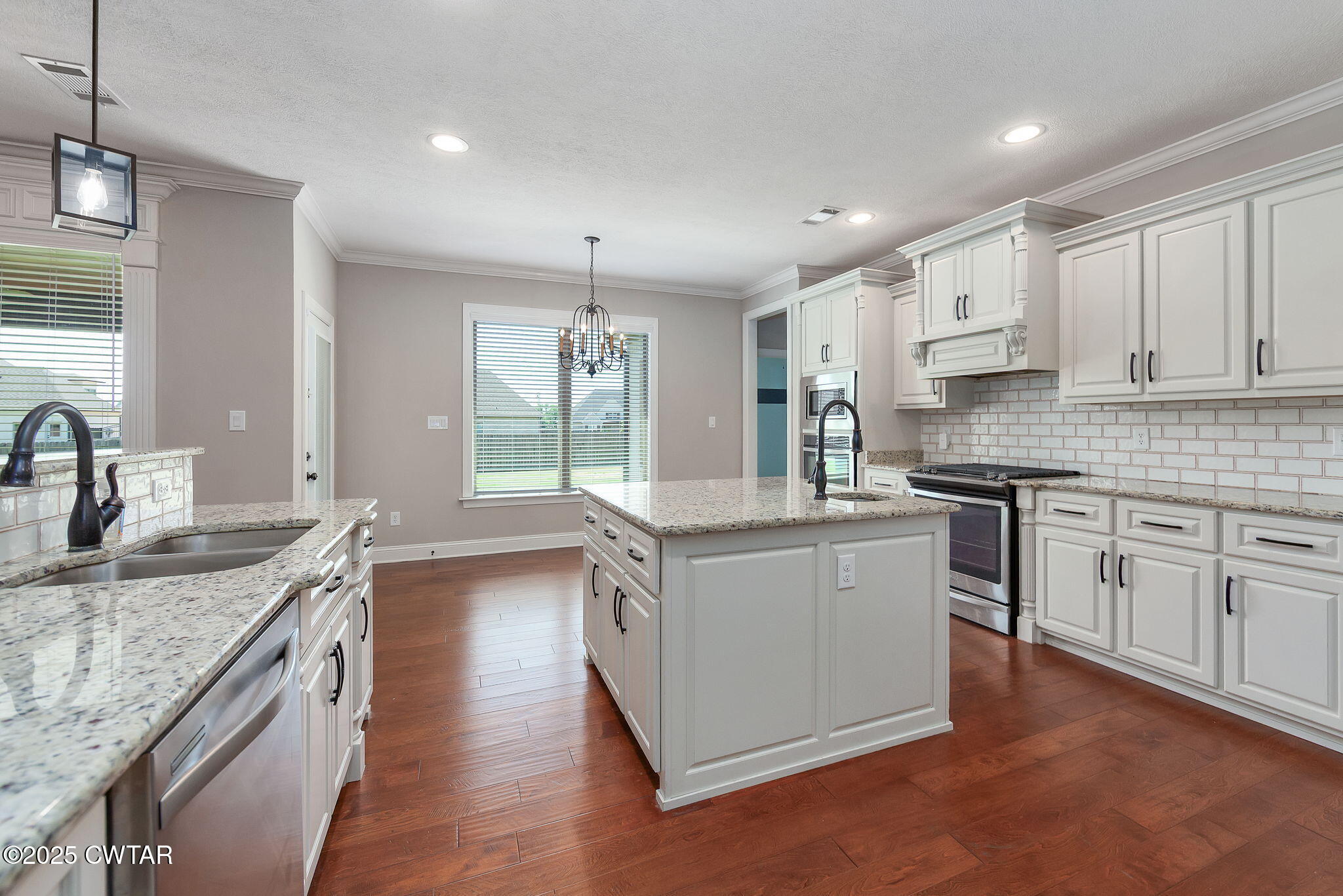42 Cheddleton Cove Jackson, TN 38305 - Photo 12 of 37 a kitchen with stainless steel appliances granite countertop a sink stove and cabinets