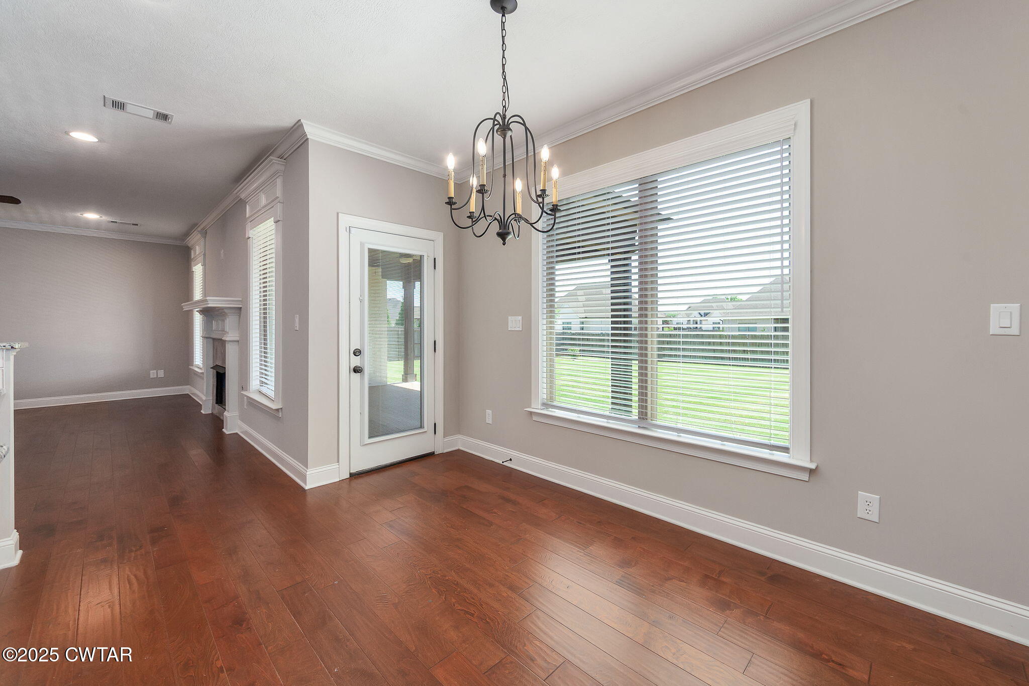42 Cheddleton Cove Jackson, TN 38305 - Photo 13 of 37 a view of an empty room with wooden floor and a window