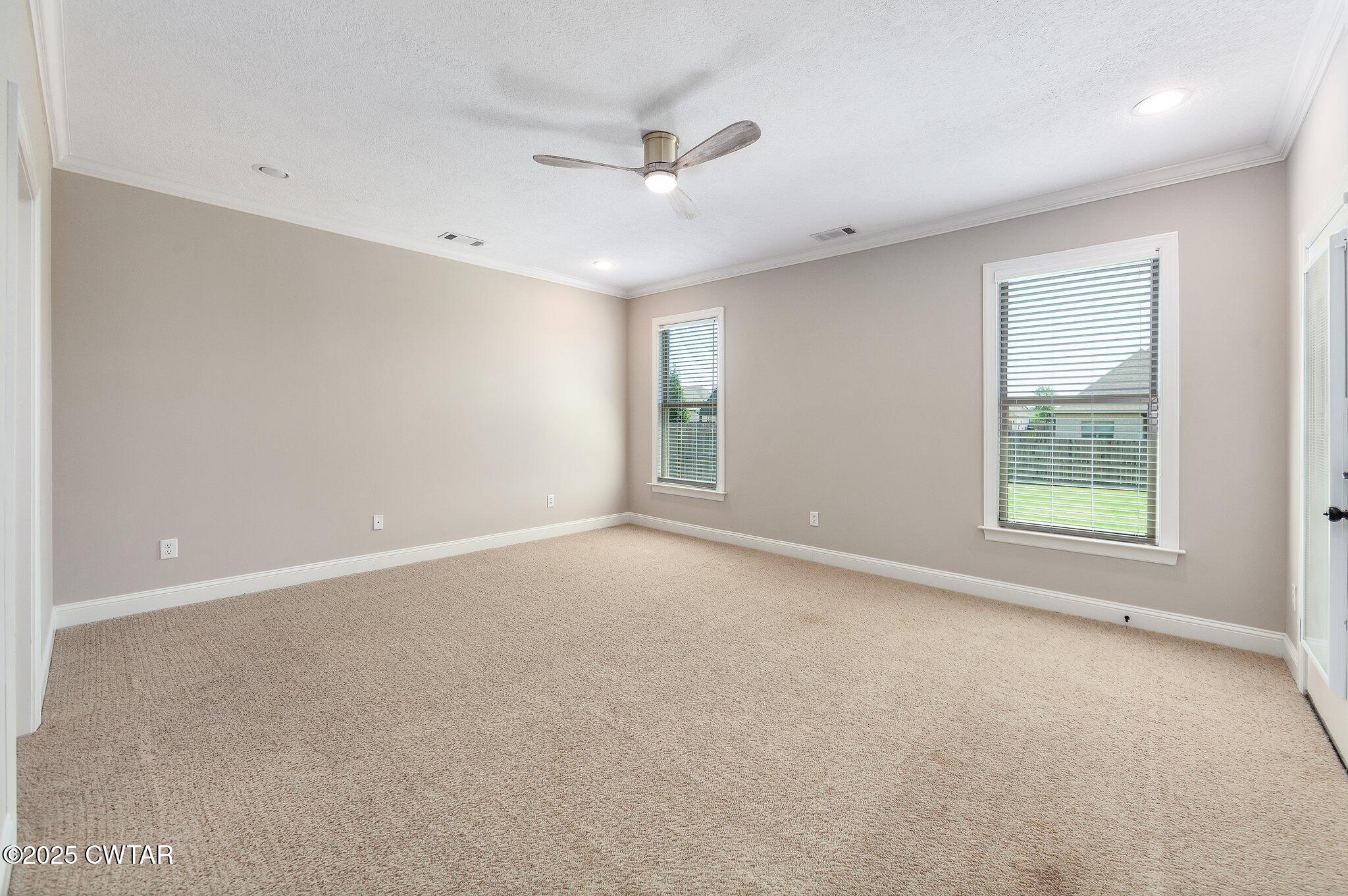 42 Cheddleton Cove Jackson, TN 38305 - Photo 14 of 37 an empty room with windows and ceiling fan
