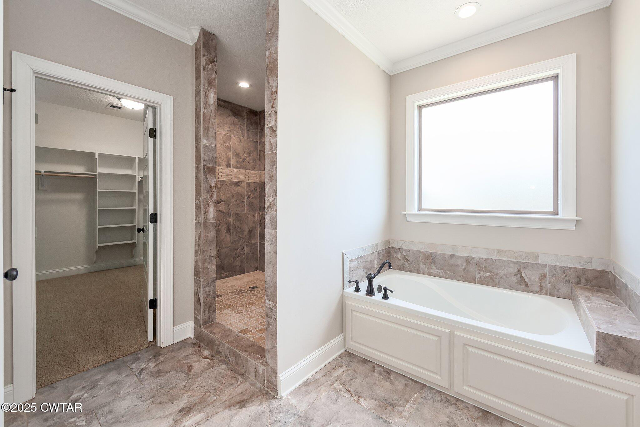 42 Cheddleton Cove Jackson, TN 38305 - Photo 16 of 37 a spacious bathroom with a bathtub and a shower