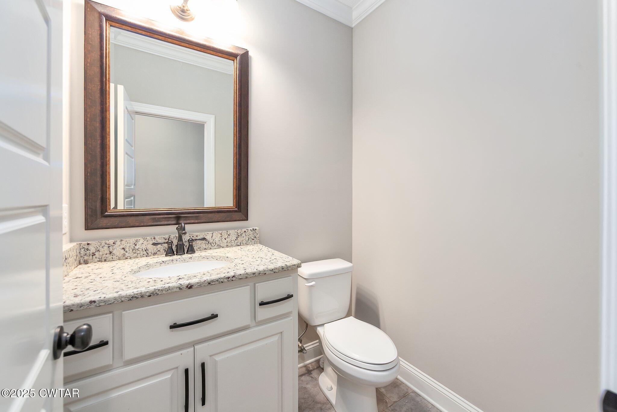 42 Cheddleton Cove Jackson, TN 38305 - Photo 22 of 37 a bathroom with a granite countertop toilet sink and mirror
