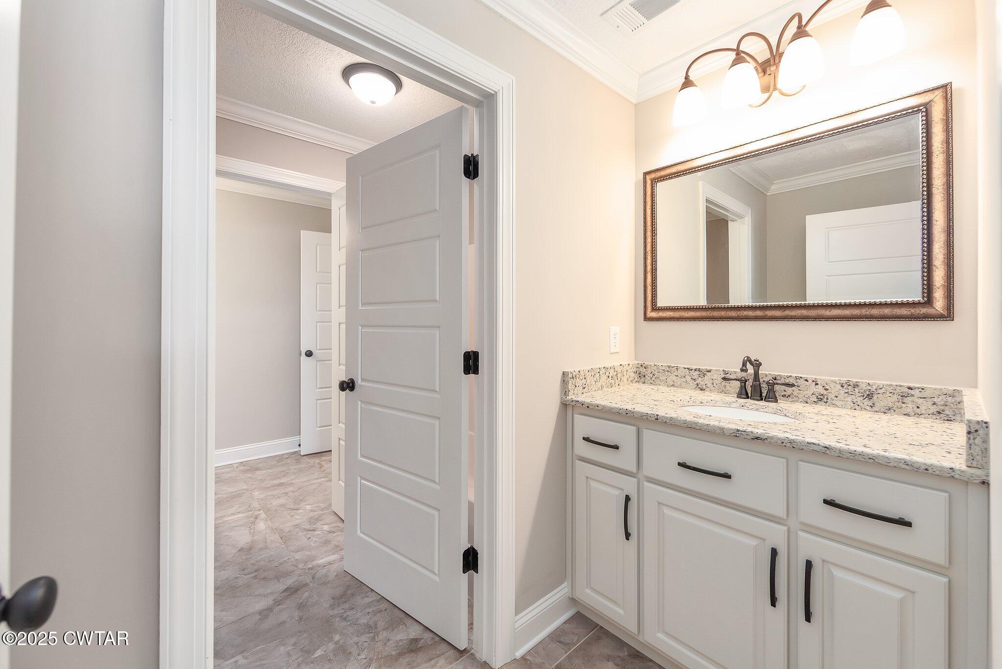 42 Cheddleton Cove Jackson, TN 38305 - Photo 25 of 37 a bathroom with a granite countertop sink vanity and mirror