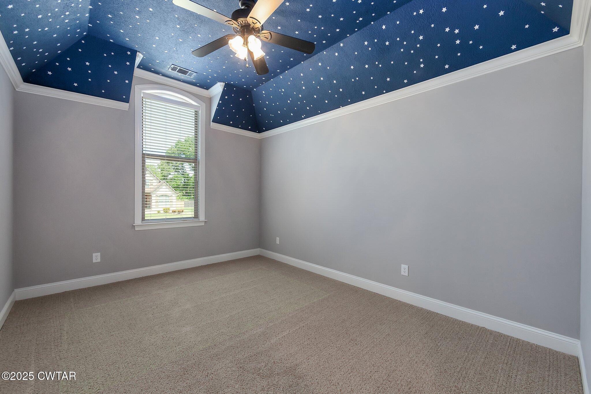 42 Cheddleton Cove Jackson, TN 38305 - Photo 27 of 37 en empty room with windows and chandelier fan
