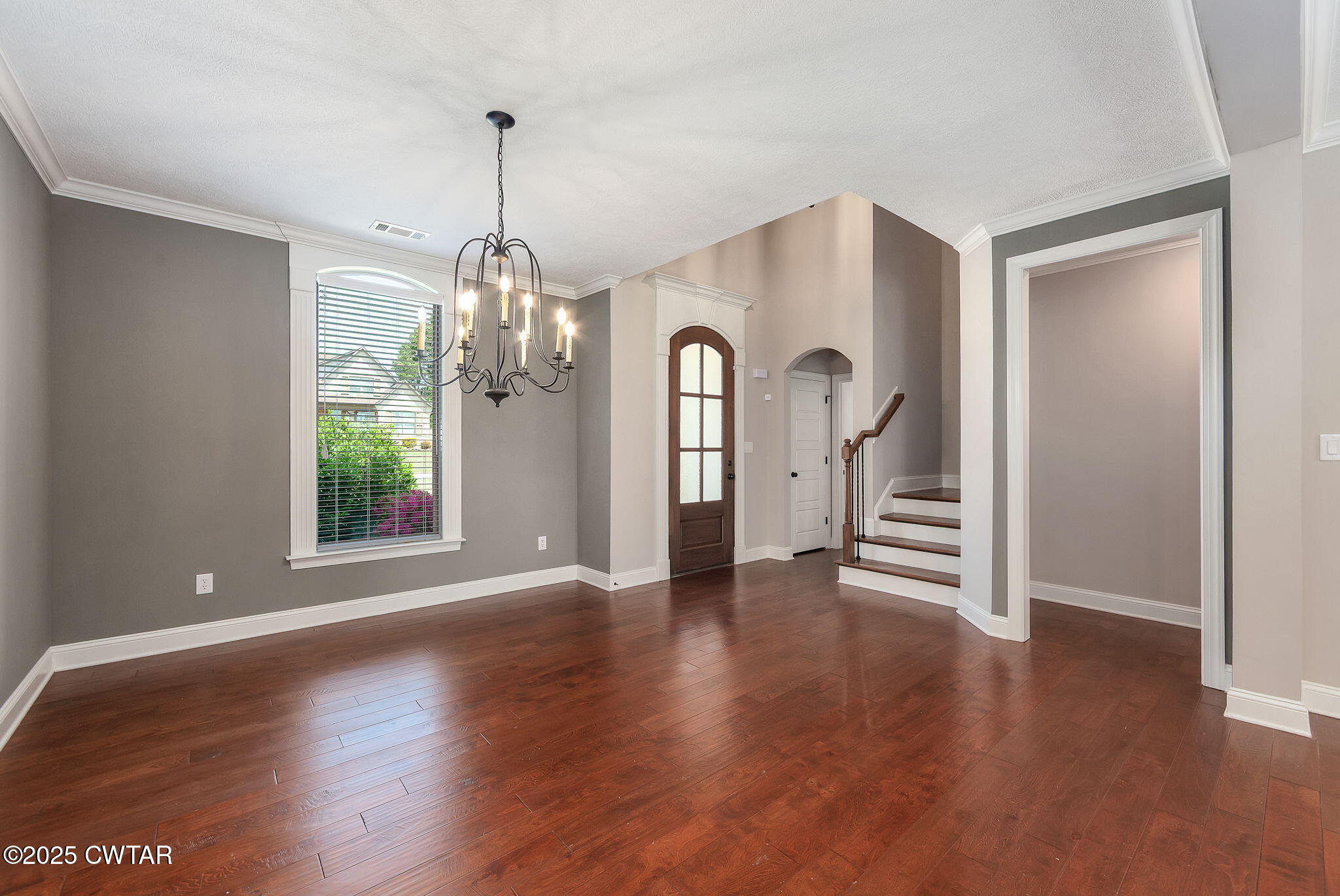 42 Cheddleton Cove Jackson, TN 38305 - Photo 4 of 37 a view of a room with wooden floors windows and a chandelier