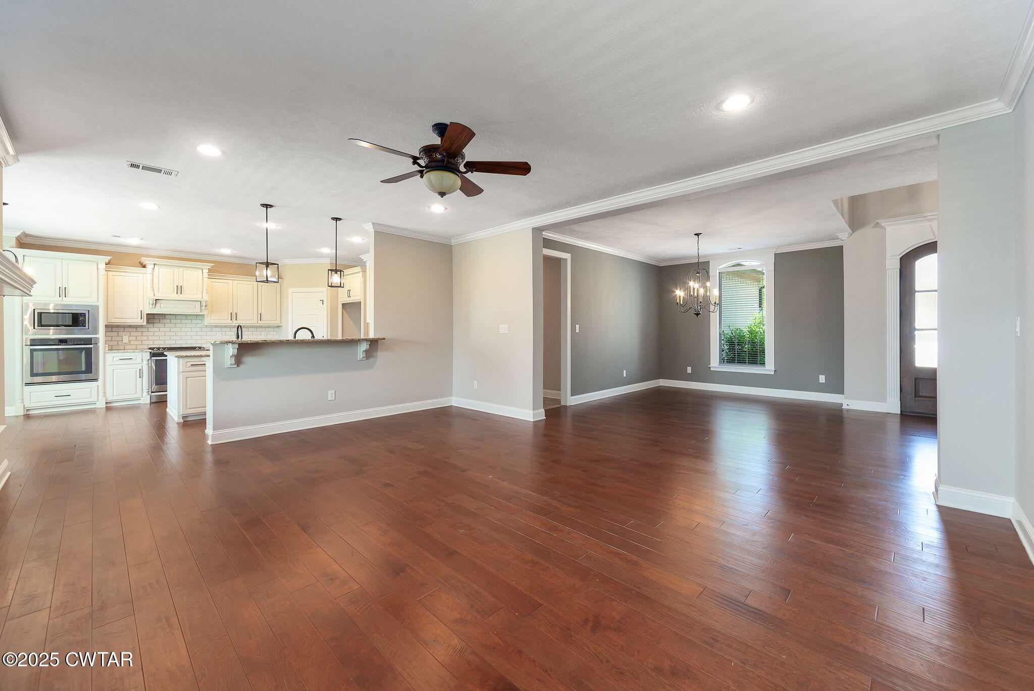 42 Cheddleton Cove Jackson, TN 38305 - Photo 6 of 37 a view of a living room a kitchen and a stove