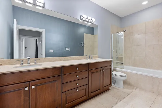 a bathroom with a double vanity sink toilet and a mirror
