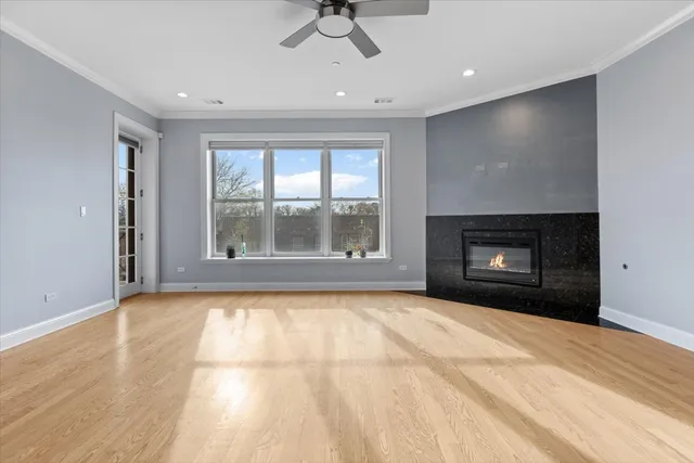 a view of an empty room with a fireplace and a window