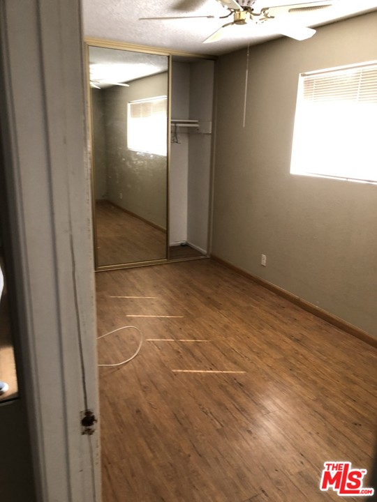 70071 Cobb Road Rancho Mirage, CA 92270 - Photo 14 of 22 a room with a wooden floor and a window
