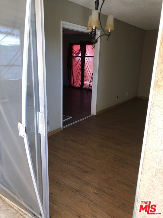70071 Cobb Road Rancho Mirage, CA 92270 - Photo 3 of 22 a view of a hallway with wooden floor and windows