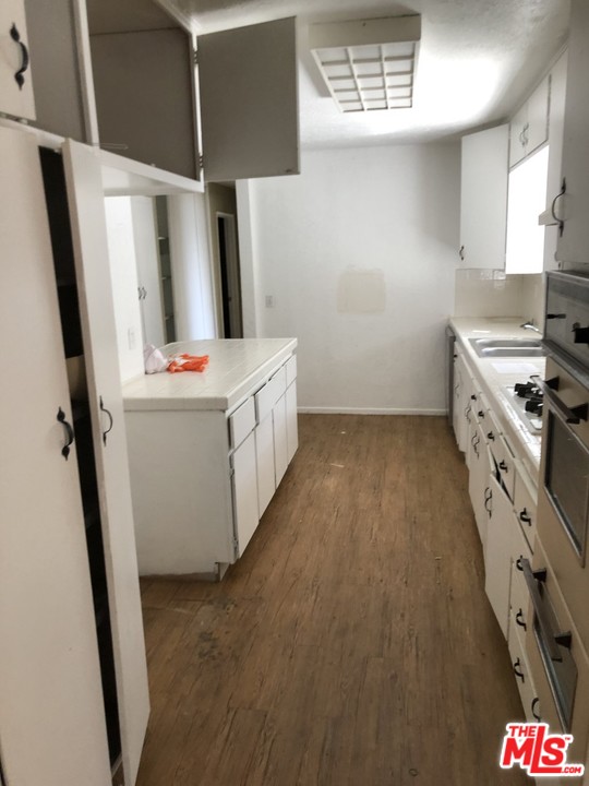 70071 Cobb Road Rancho Mirage, CA 92270 - Photo 4 of 22 a kitchen with stainless steel appliances a stove top oven a refrigerator a sink and dishwasher