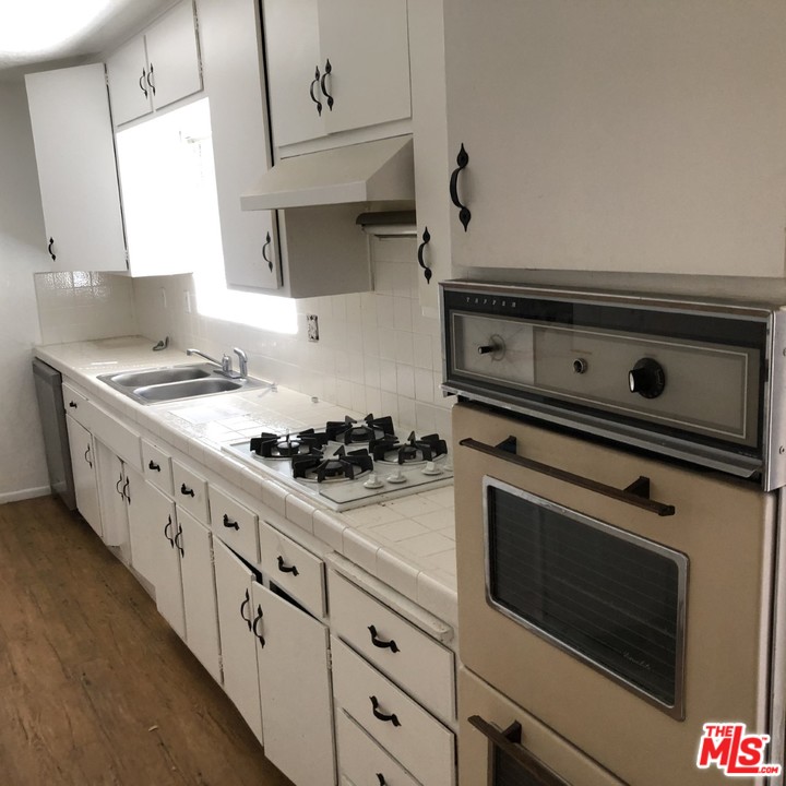 70071 Cobb Road Rancho Mirage, CA 92270 - Photo 5 of 22 a white stove top oven sitting inside of a kitchen