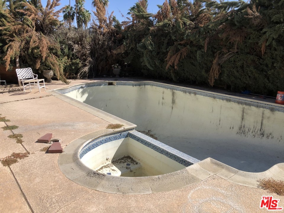 70071 Cobb Road Rancho Mirage, CA 92270 - Photo 8 of 22 a view of a swimming pool and trees in the background
