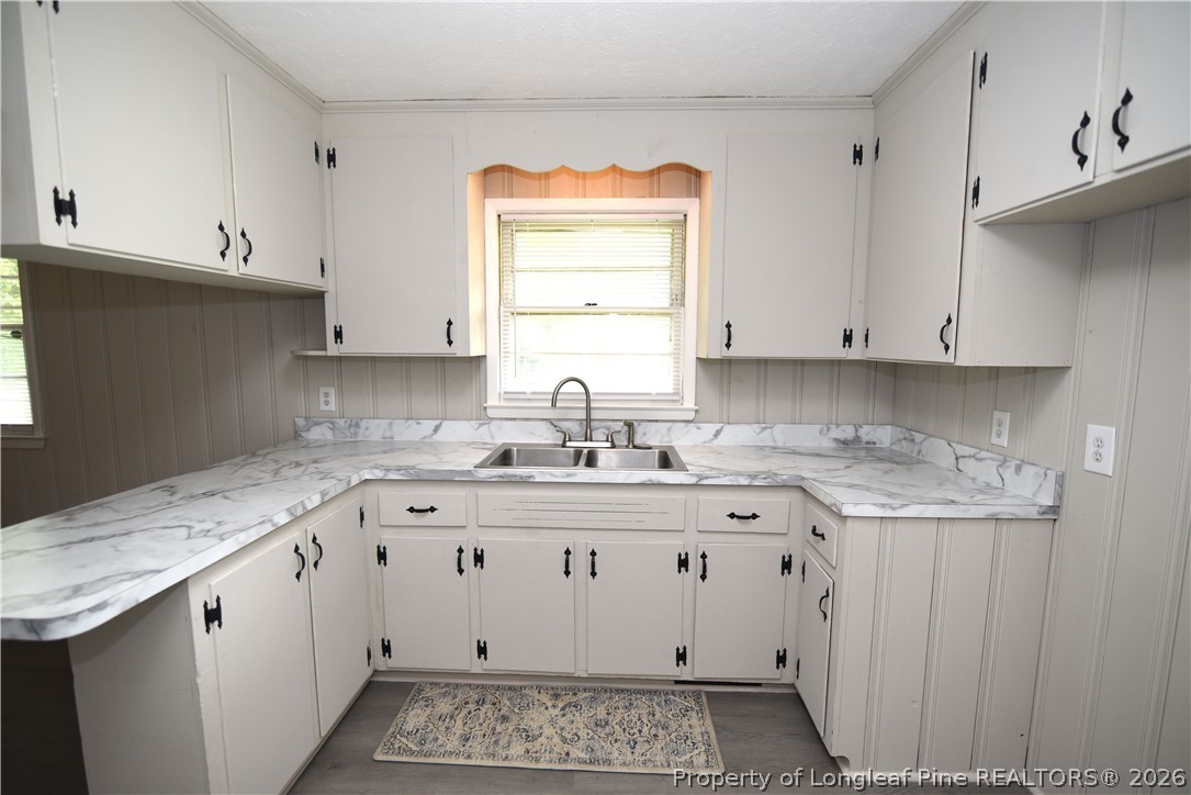 1673 Norment Road Lumberton, NC 28360 - Photo 12 of 32 a kitchen with granite countertop a sink and cabinets
