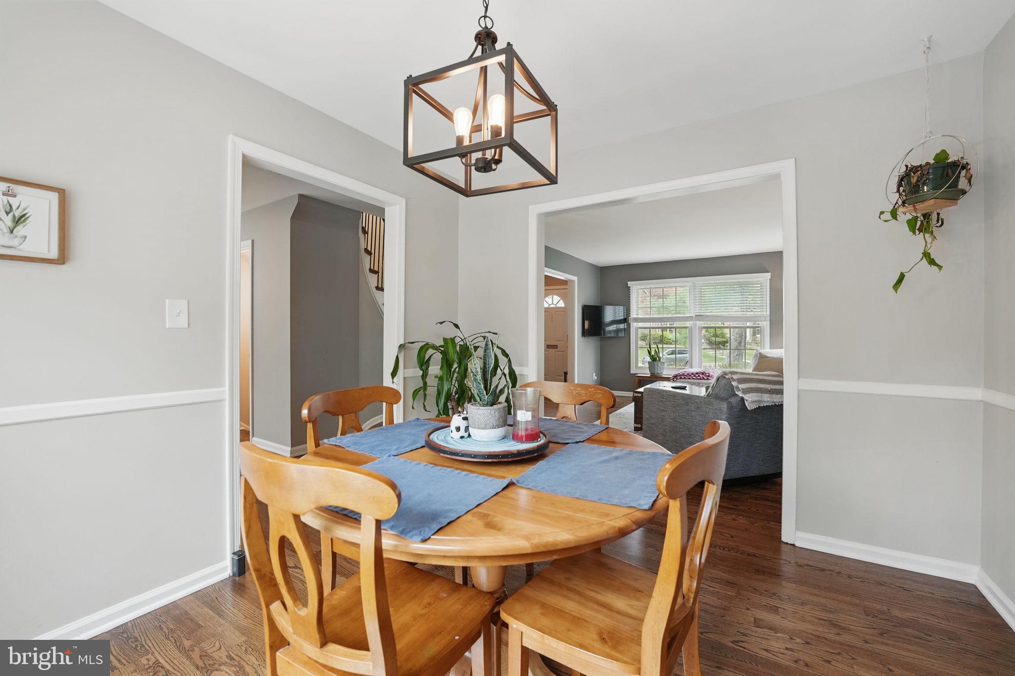 8333 Wickham Road Springfield, VA 22152 - Photo 11 of 54 a view of a dining room with furniture wooden floor and a chandelier