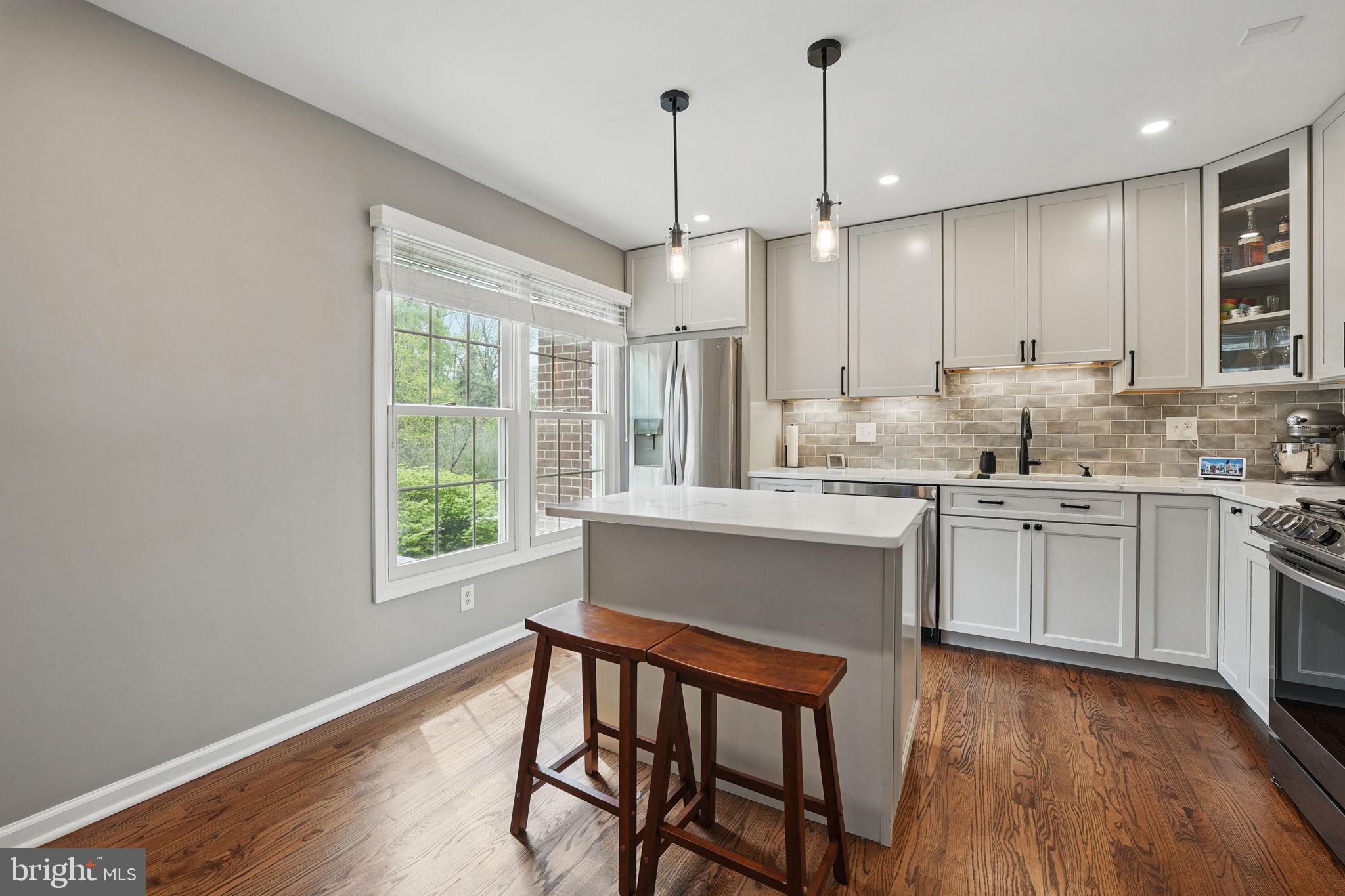 8333 Wickham Road Springfield, VA 22152 - Photo 15 of 54 a kitchen with a window a sink appliances and cabinets