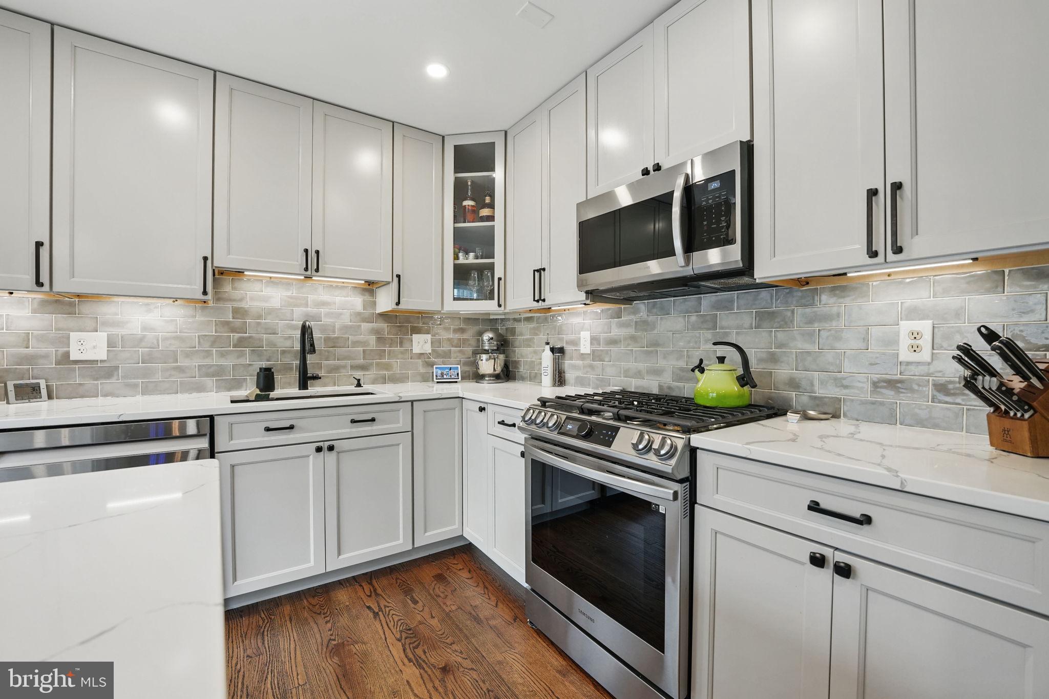 8333 Wickham Road Springfield, VA 22152 - Photo 17 of 54 a kitchen with stainless steel appliances granite countertop a stove a sink and a microwave