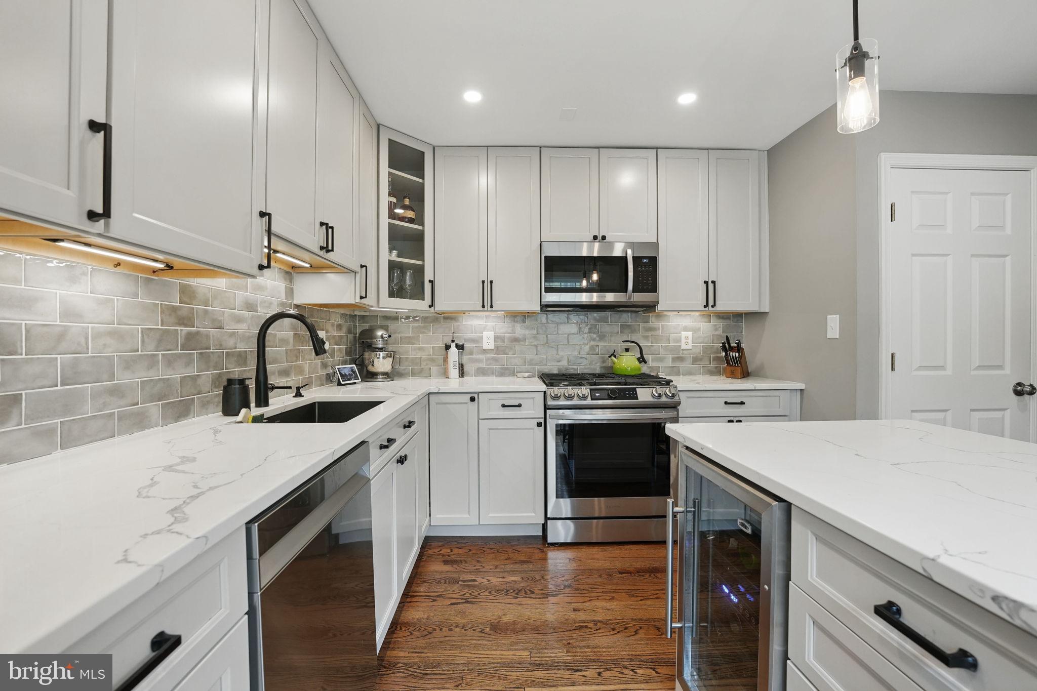 8333 Wickham Road Springfield, VA 22152 - Photo 19 of 54 a kitchen with a sink a stove and cabinets