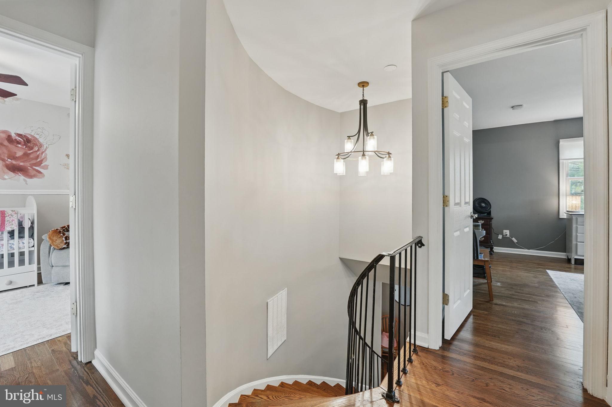 8333 Wickham Road Springfield, VA 22152 - Photo 23 of 54 a view of a hallway with wooden floor and staircase