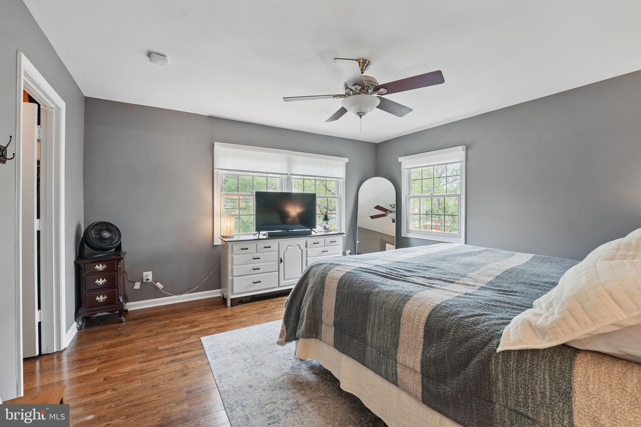 8333 Wickham Road Springfield, VA 22152 - Photo 24 of 54 a bedroom with a large bed and a tv