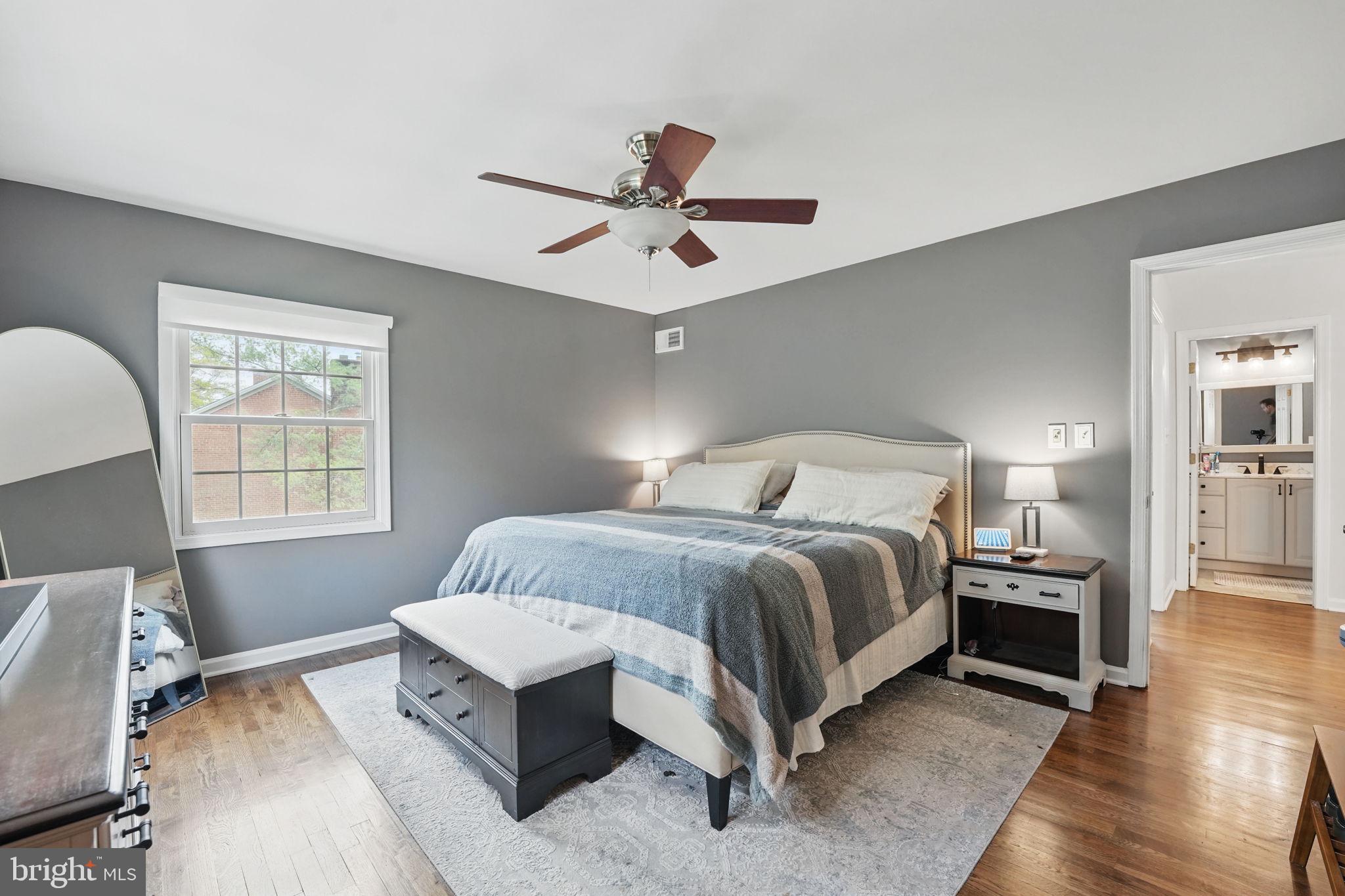 8333 Wickham Road Springfield, VA 22152 - Photo 25 of 54 a bedroom with a bed and wooden floor