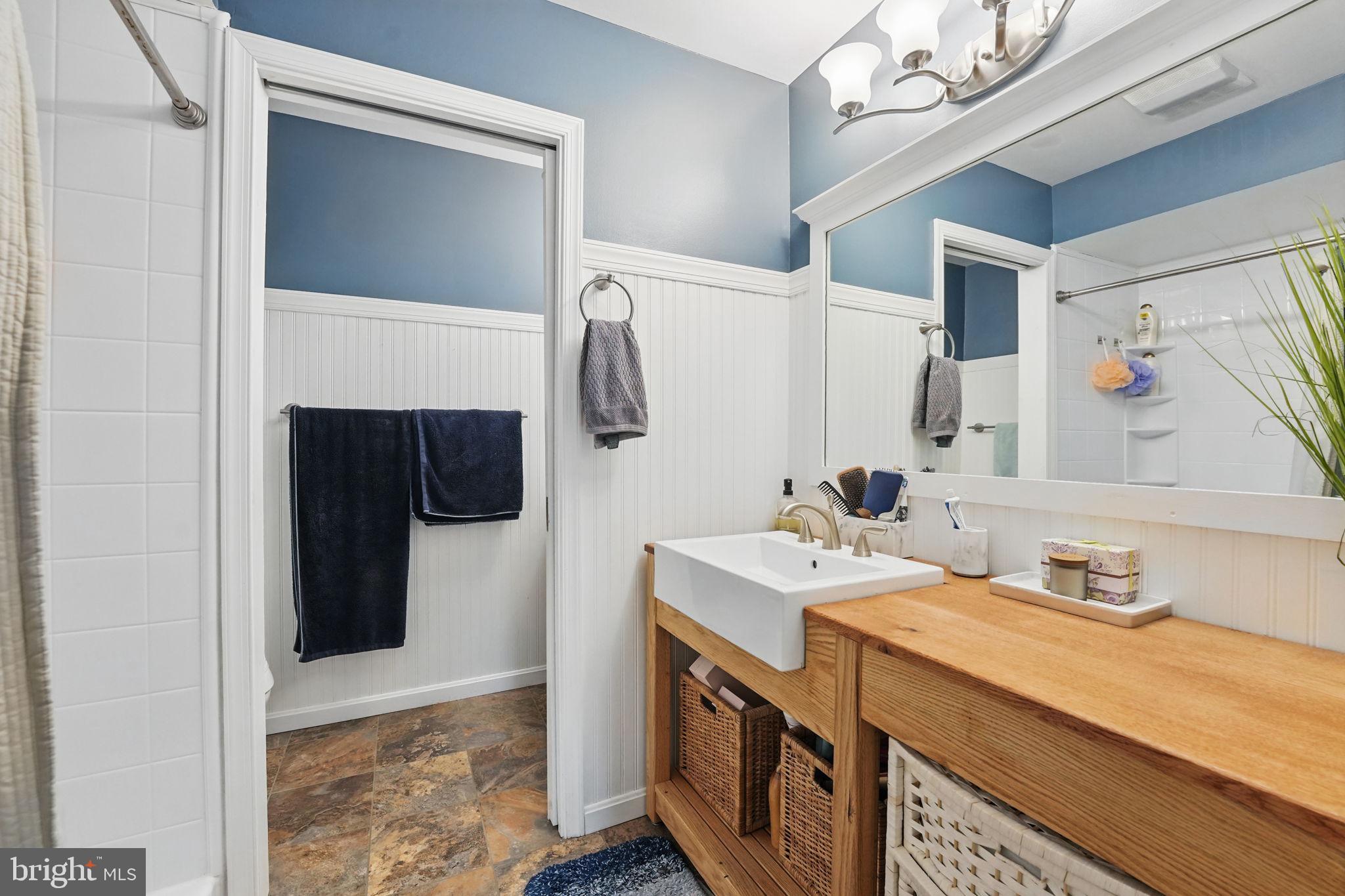 8333 Wickham Road Springfield, VA 22152 - Photo 28 of 54 a bathroom with a sink a toilet and a mirror