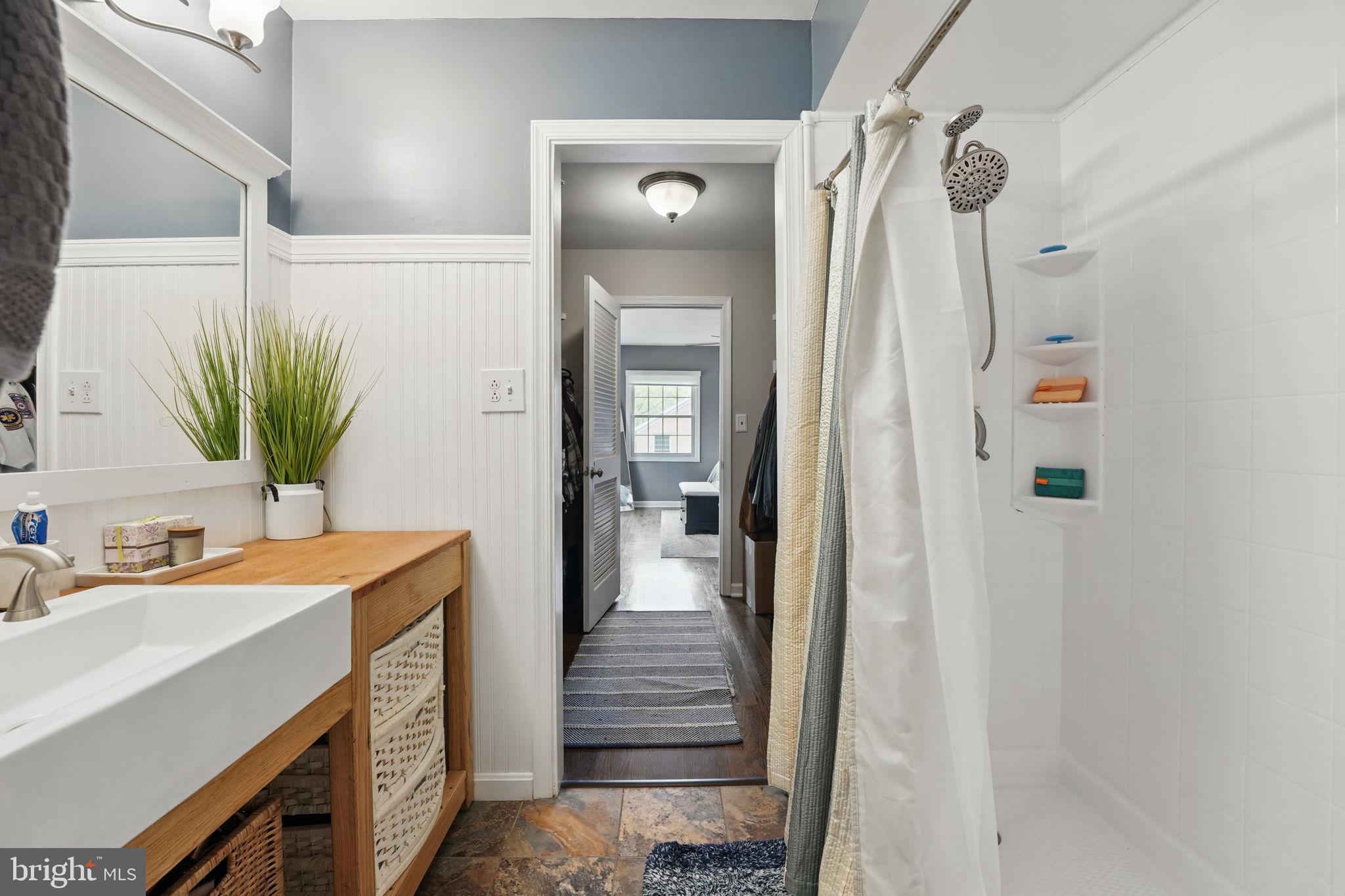 8333 Wickham Road Springfield, VA 22152 - Photo 30 of 54 a bathroom with a sink a mirror a vanity and shower