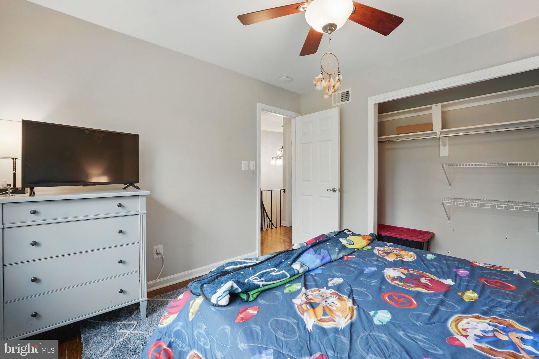 8333 Wickham Road Springfield, VA 22152 - Photo 32 of 54 a bedroom with a bed and flat screen tv