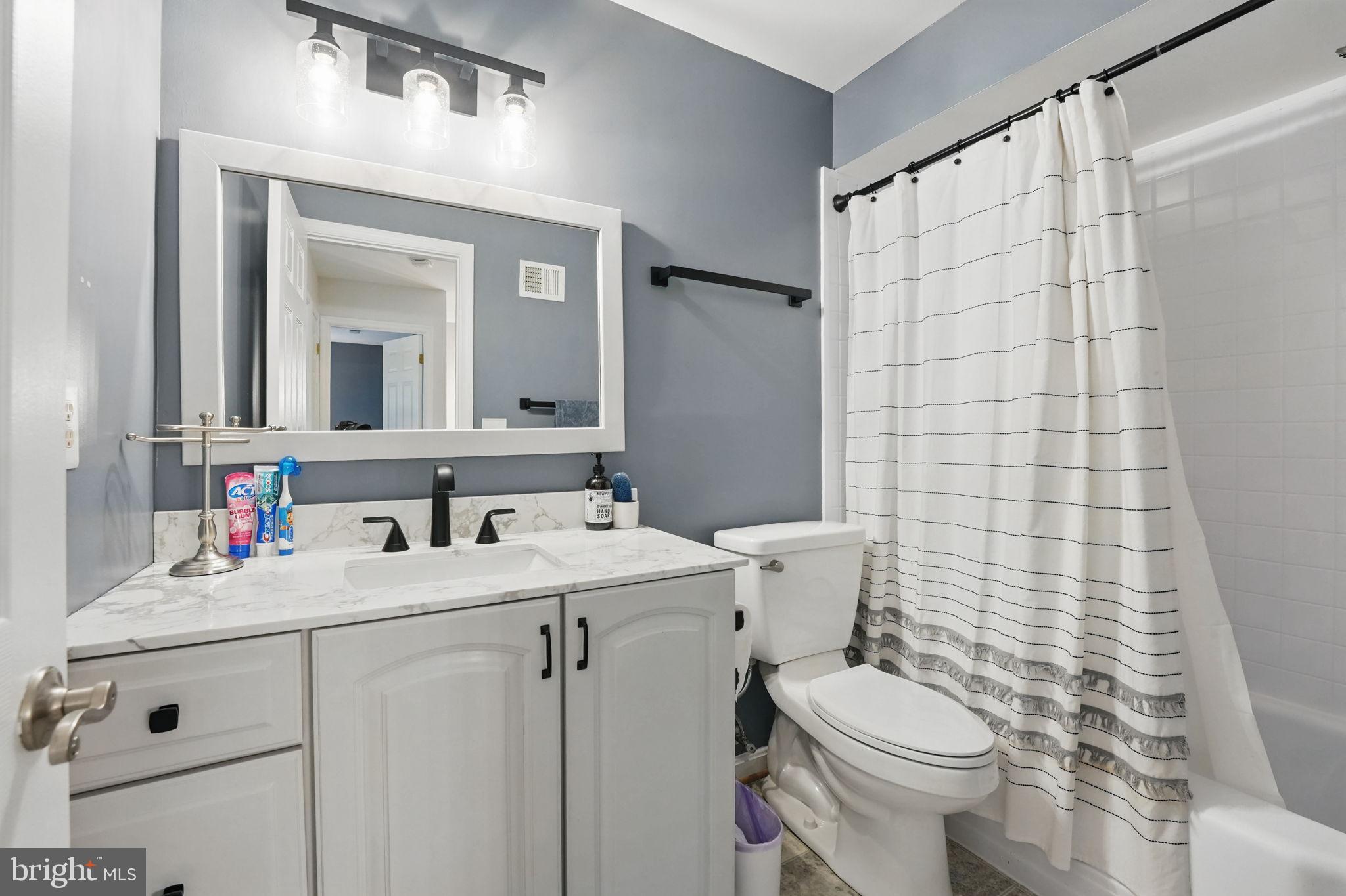 8333 Wickham Road Springfield, VA 22152 - Photo 33 of 54 a bathroom with a sink and a mirror